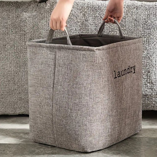 Foldable laundry basket with reinforced handles